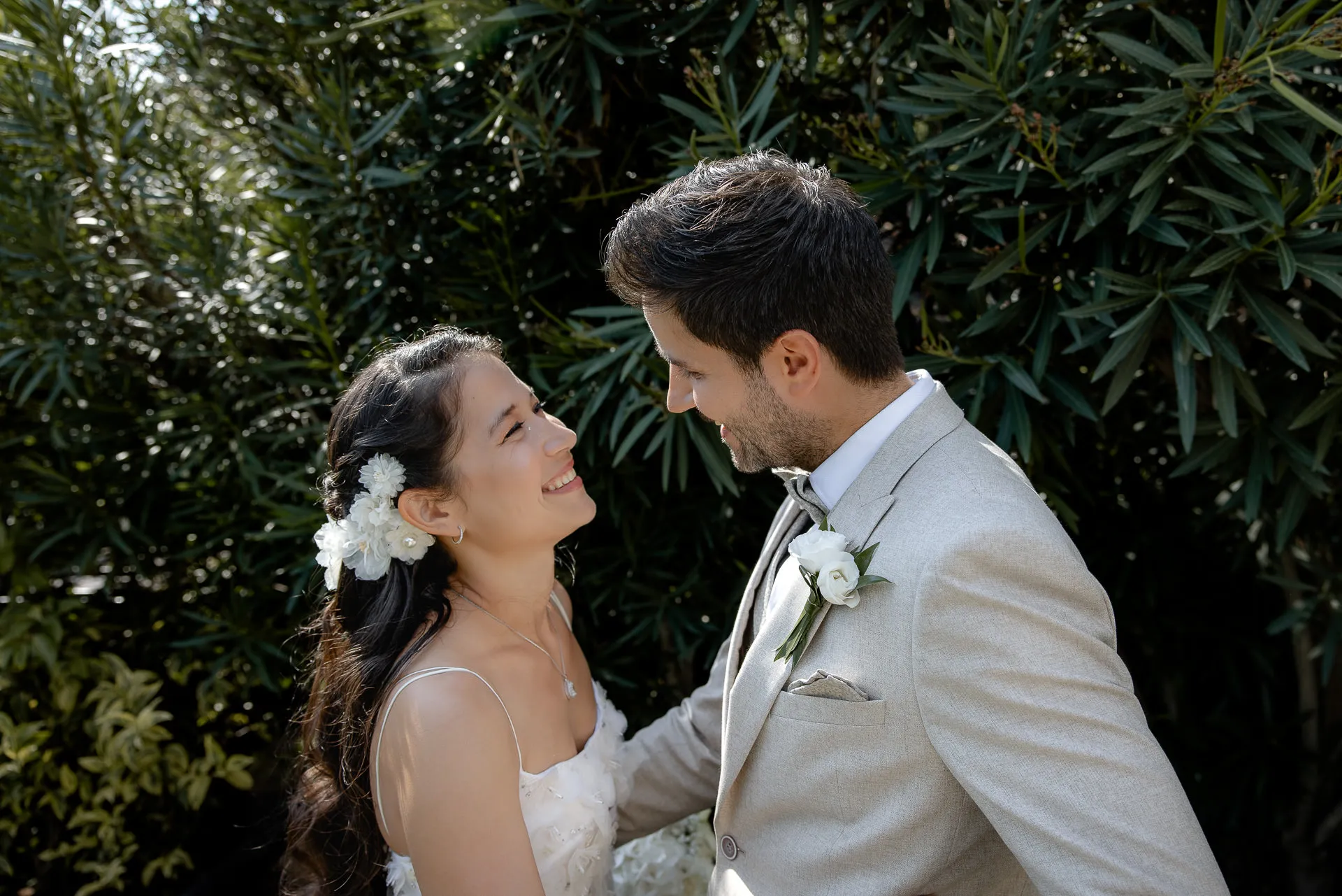 Loving wedding couple in emotional moment in Mediterranean garden