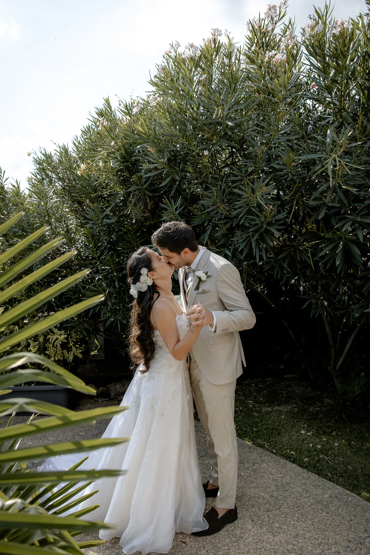Romantic kiss of wedding couple in Mediterranean garden at Villa Cariola