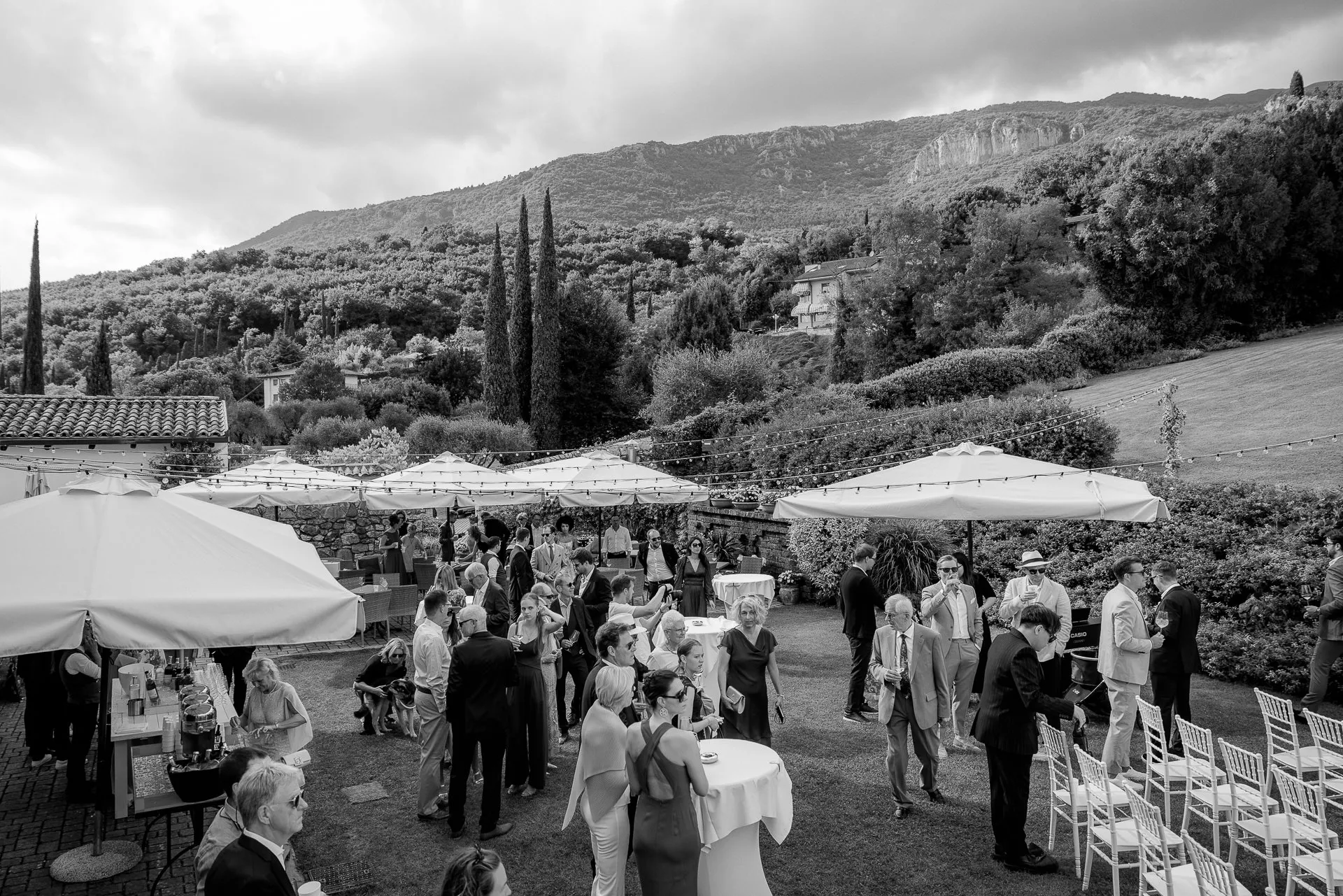 Wedding reception with guests in front of dramatic mountain panorama at Lake Garda