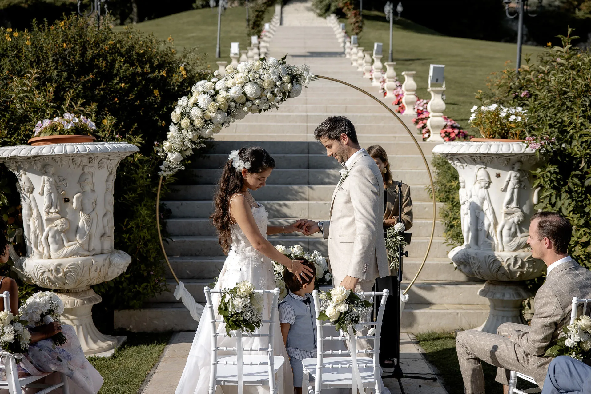 Emotional outdoor ceremony with ring exchange in front of grand staircase at Villa Cariola