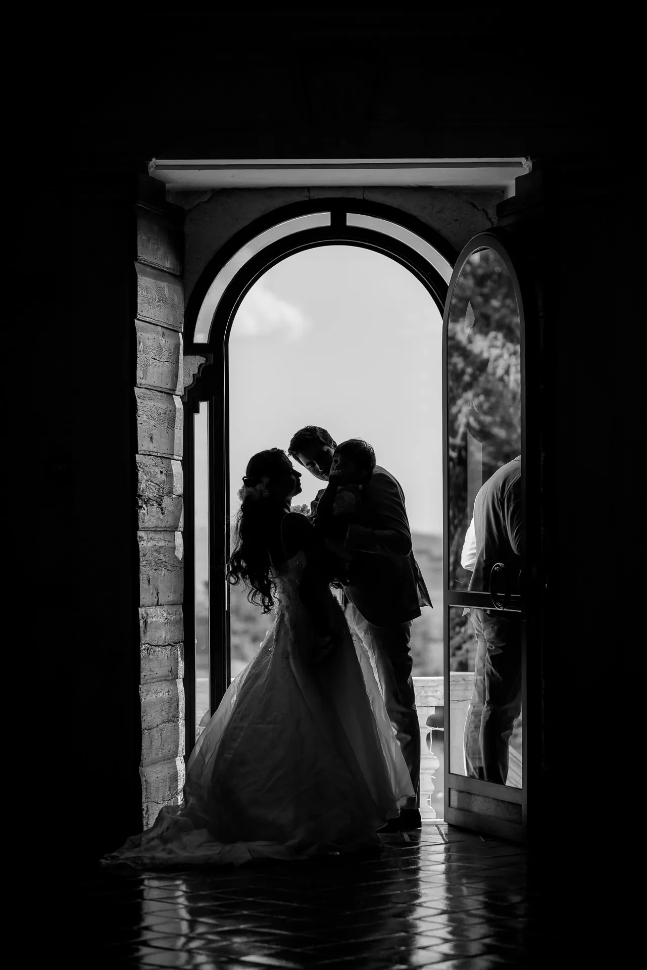 Romantic silhouette of wedding couple in historic archway at Villa Cariola
