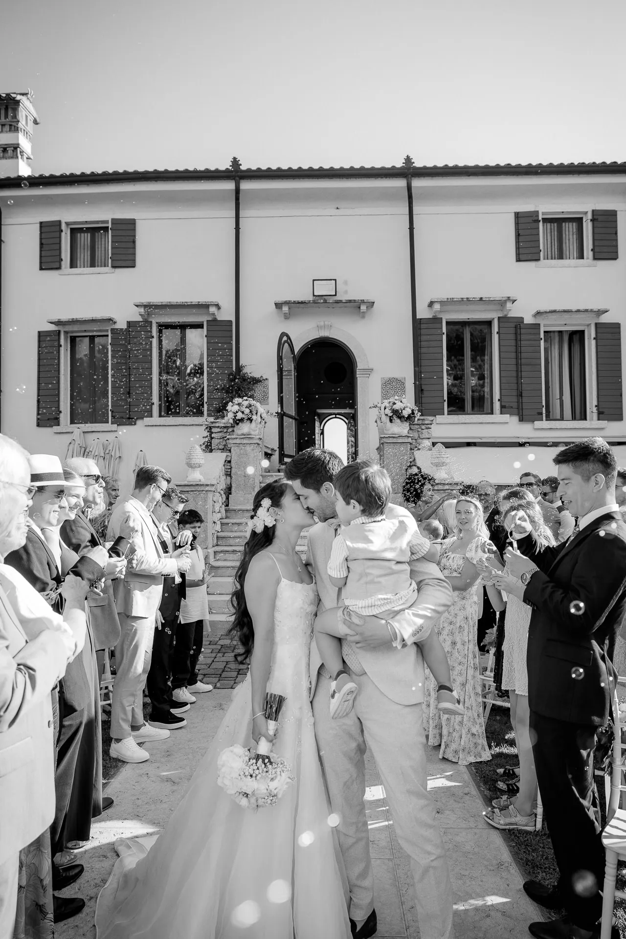 Intimate kiss of wedding couple after ceremony in front of Villa Cariola