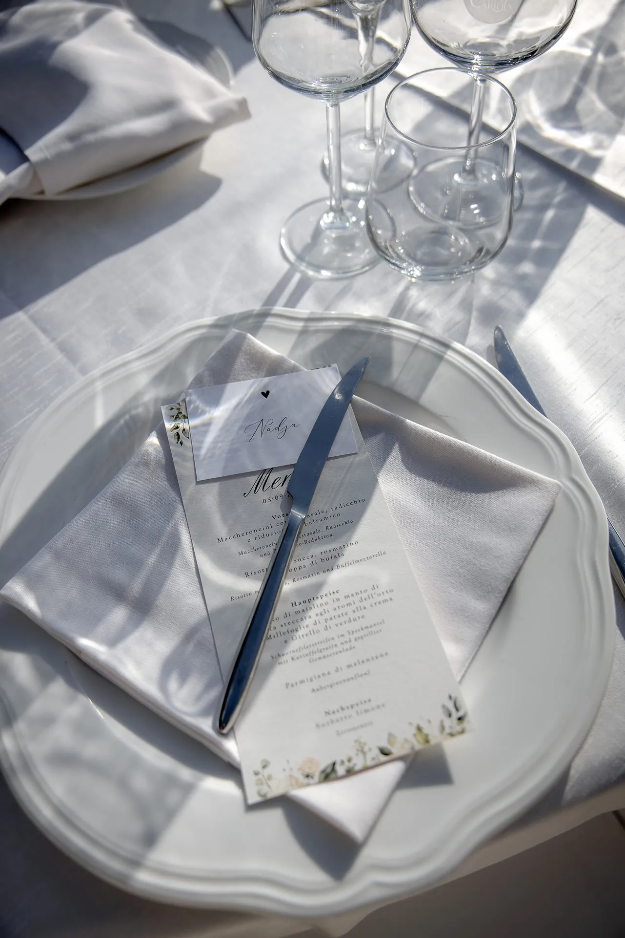 Elegant table decoration with menu card and place card at wedding reception