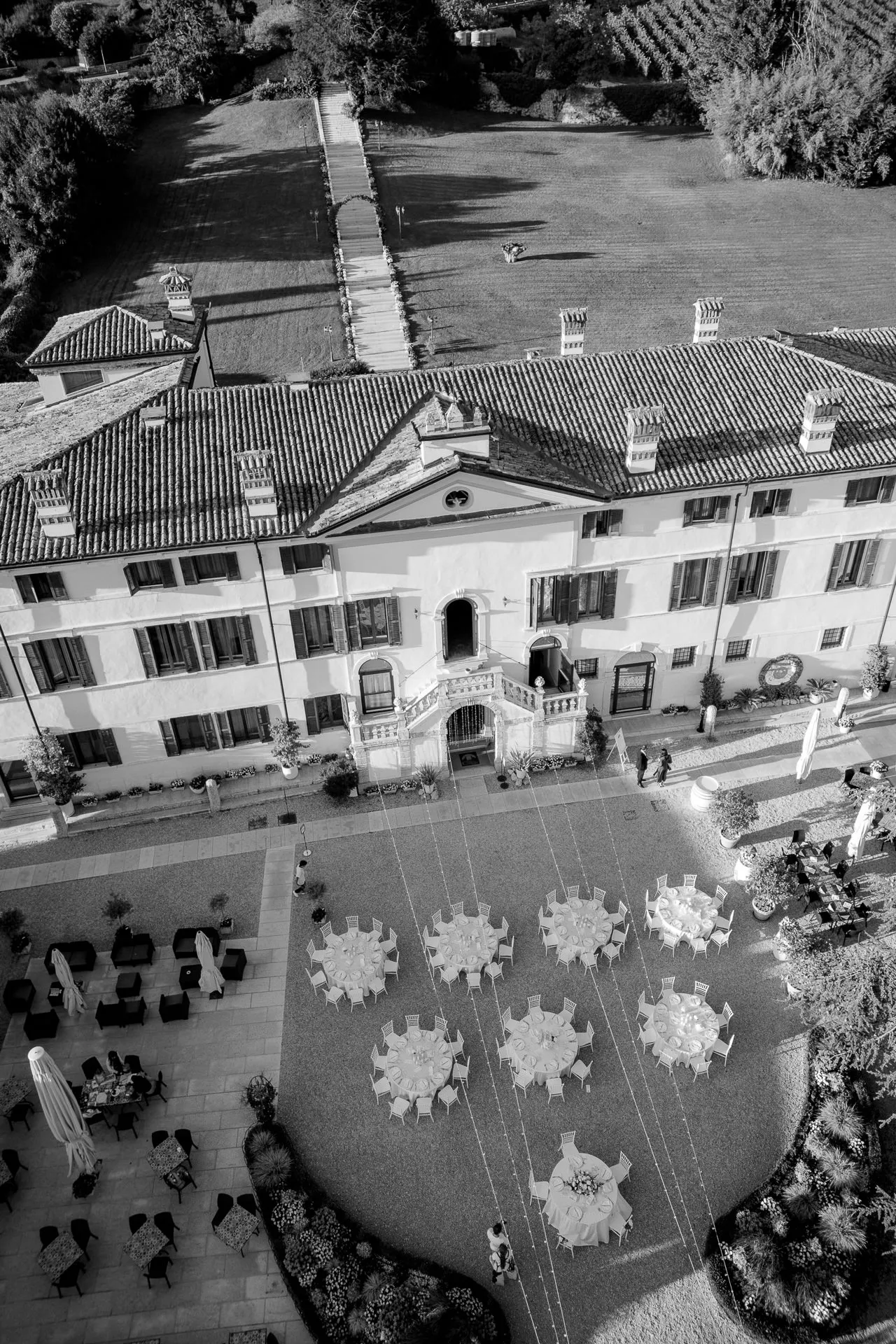 Spectacular aerial view of Villa Cariola with wedding celebration and vineyards