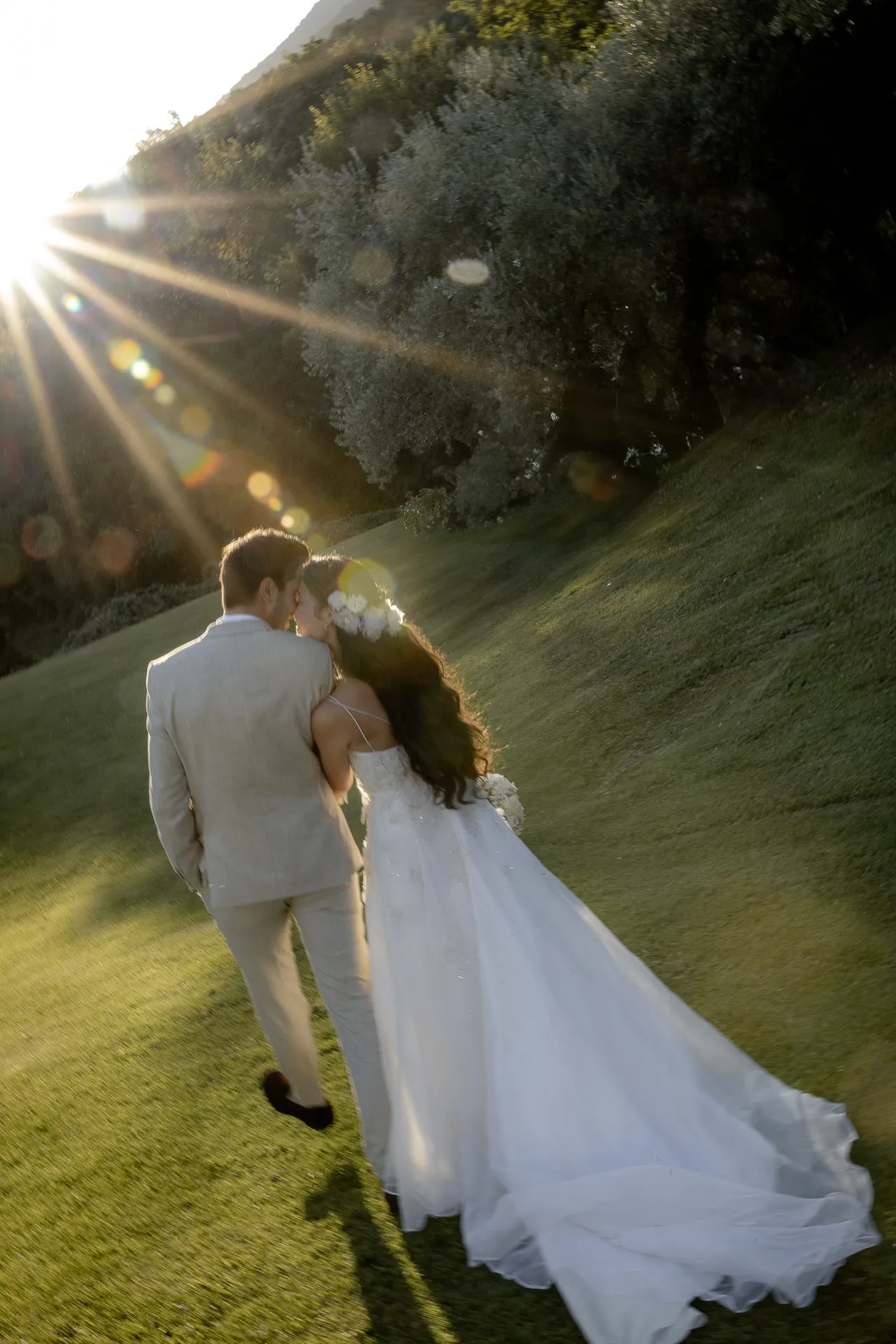 Romantic wedding couple backlit at sunset at Lake Garda