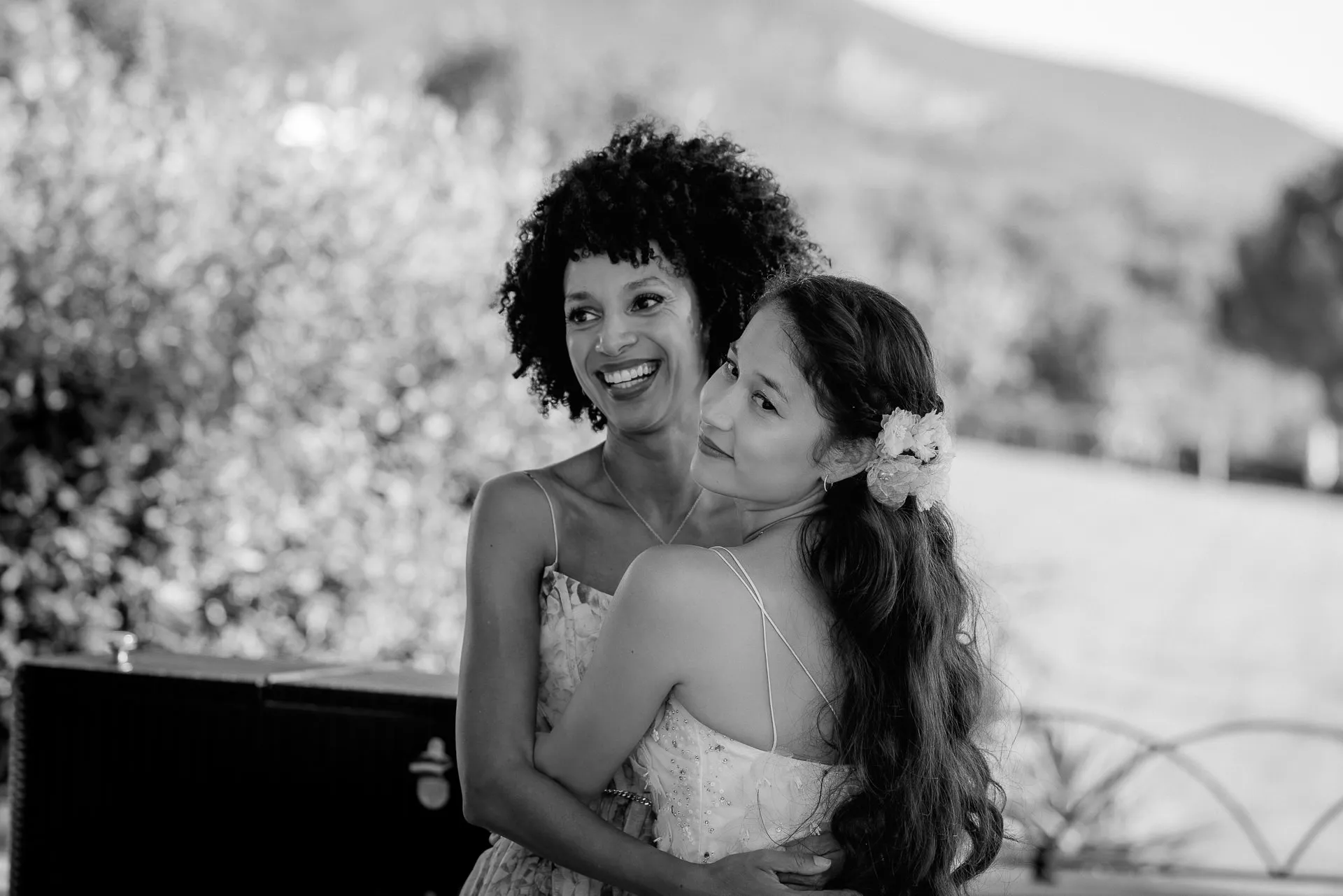 Bride with wedding guest in black and white at celebration at Lake Garda